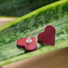 Load image into Gallery viewer, Heart-shaped earrings on a green leaf
