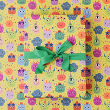 Load image into Gallery viewer, Gift with a green ribbon on colorful monster-patterned paper
