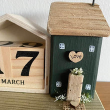 Load image into Gallery viewer, Decorative wooden house with a calendar and decorative elements on a wooden surface.

