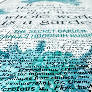 Close-up of a book page with text and a blue watercolor effect