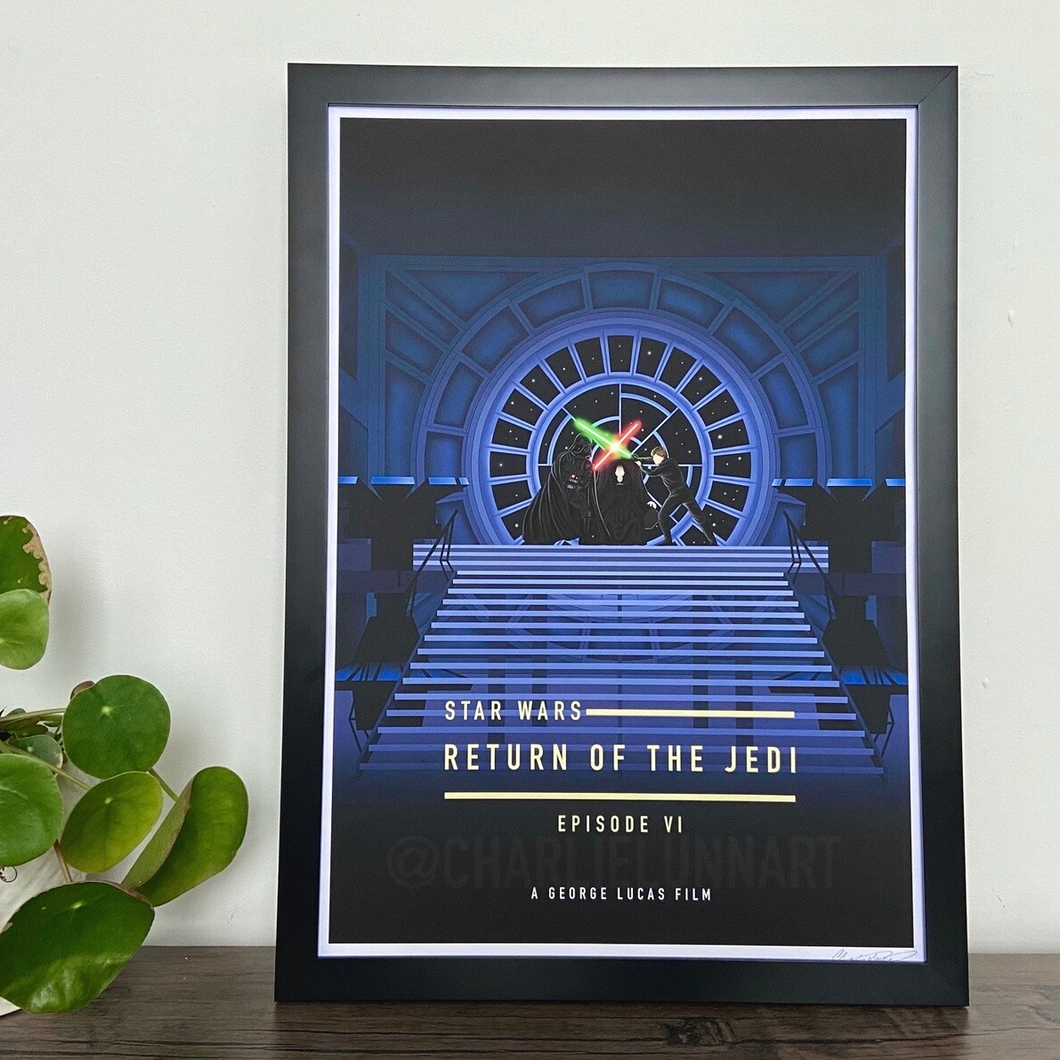 Framed 'Star Wars: Return of the Jedi' poster on a wooden surface with a plant.